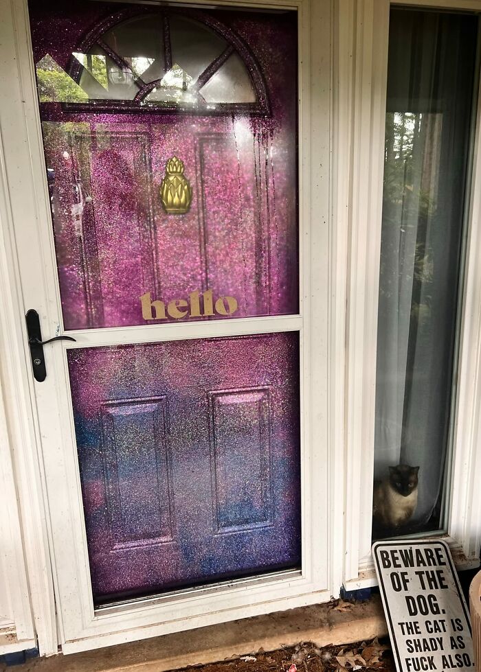 Front door with glittery purple decor piece and a golden hello sign, enhancing the magical home decor vibe.