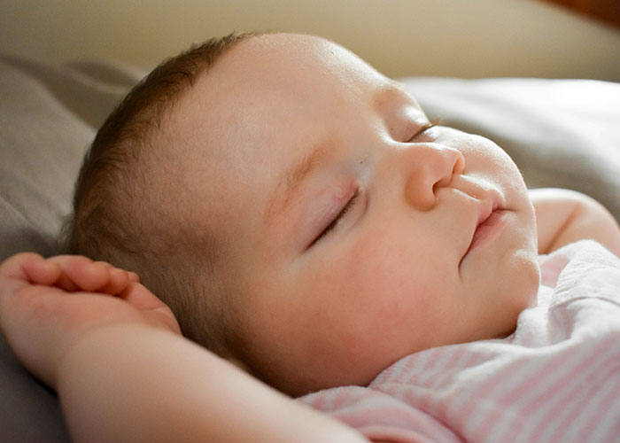 Sleeping baby peacefully resting, representing mysteries people personally experienced and still can't explain.