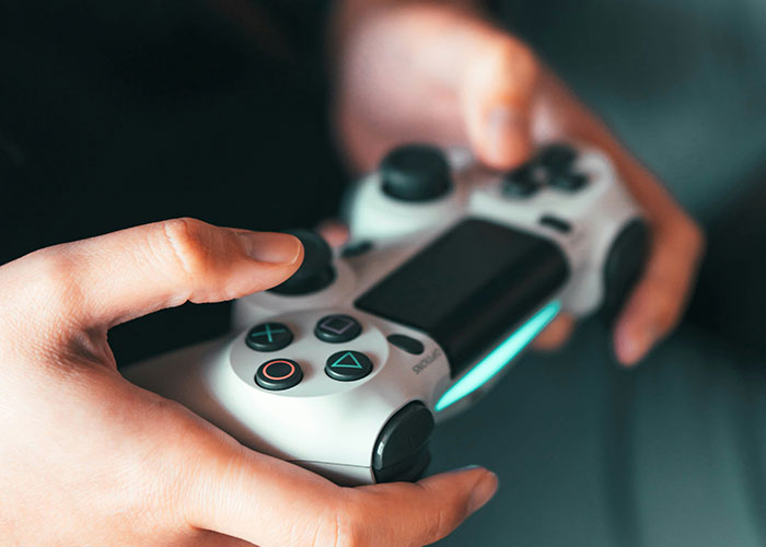 Close-up of hands holding a gaming controller, illustrating personal mysteries and unexplained experiences.