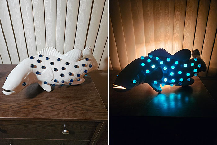 Ceramic fish thrift store find with glowing blue lights, displayed in daylight and illuminated at night on a wooden table.