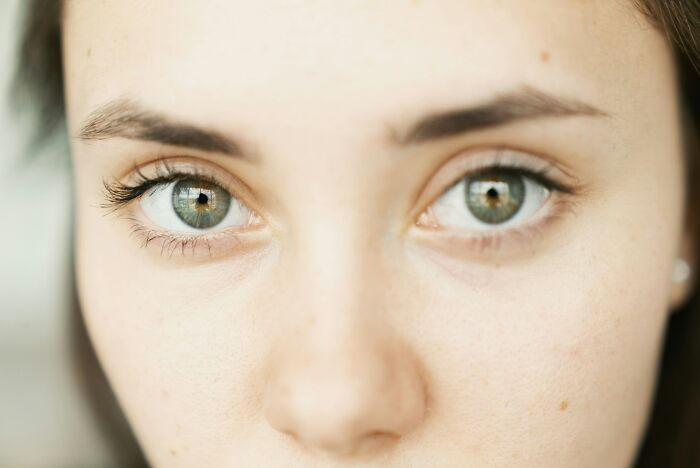 Close-up of a young person's green eyes and face, evoking the feeling of disturbing facts people shared.