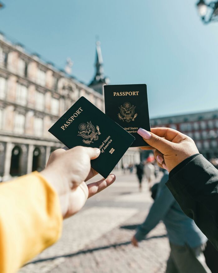 Two people holding US passports outside, symbolizing travel and sharing disturbing facts they wish they didn’t know.