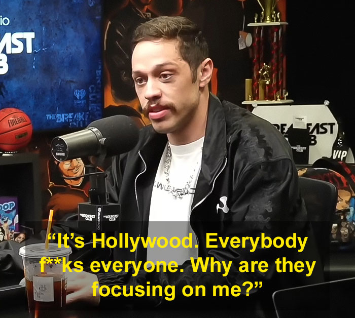 Pete Davidson speaking into a microphone during a podcast discussing scrutiny of the size of his manhood.