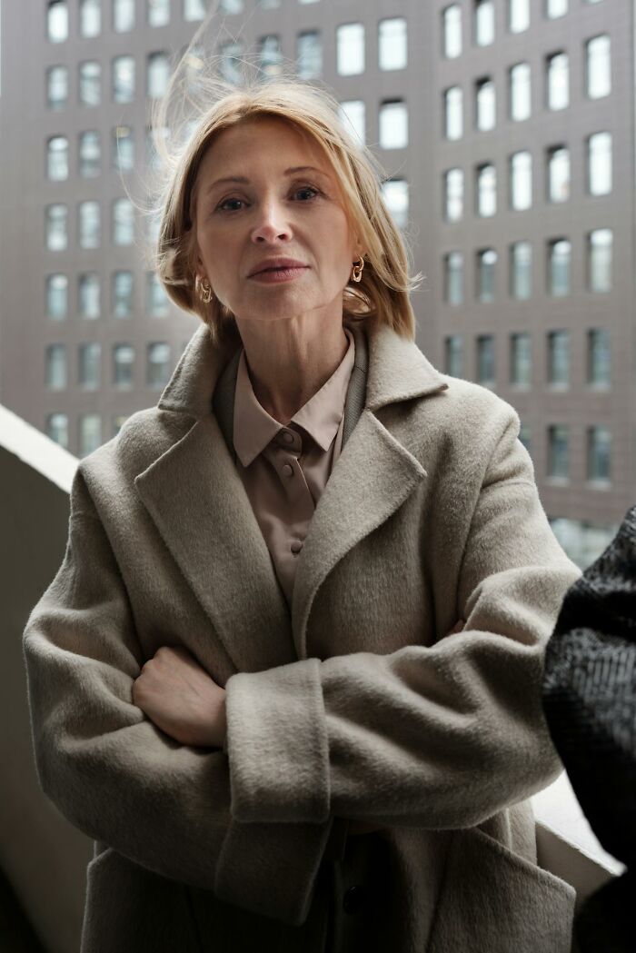 Confident woman standing outdoors in an urban setting, illustrating signs of talking to a psychopath concept.