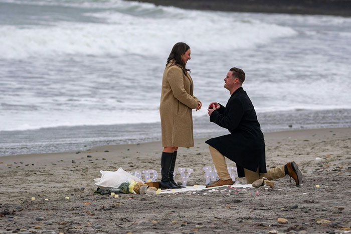 Man proposing on beach with bouquet, capturing a moment of heartbreak over wanting a rich husband not hardworking partner Man proposing on beach with bouquet, capturing a moment of heartbreak over wanting a rich husband not hardworking partner