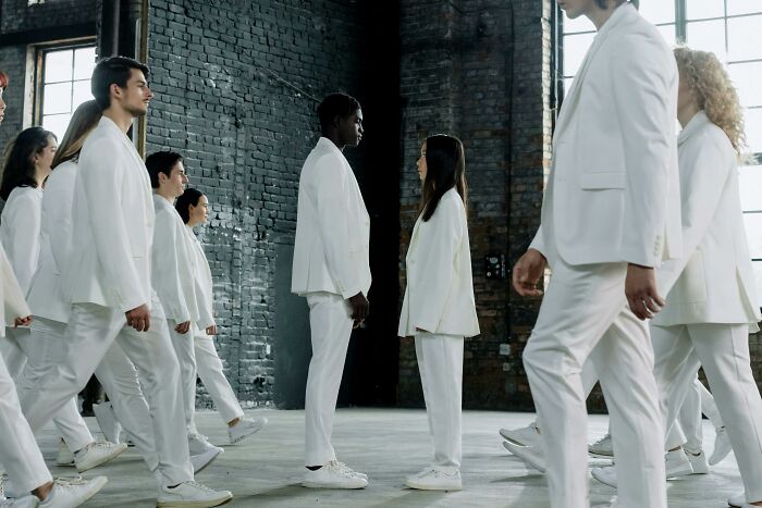 Group of diverse people in white suits facing each other, illustrating country stereotypes concept for untangling humor. Group of diverse people in white suits facing each other, illustrating country stereotypes concept for untangling humor.