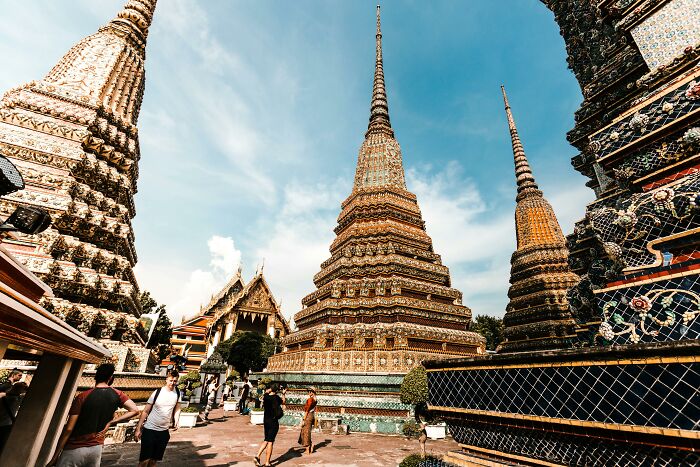 Ancient temple spires with intricate designs under blue sky, highlighting key elements of geography and world knowledge.