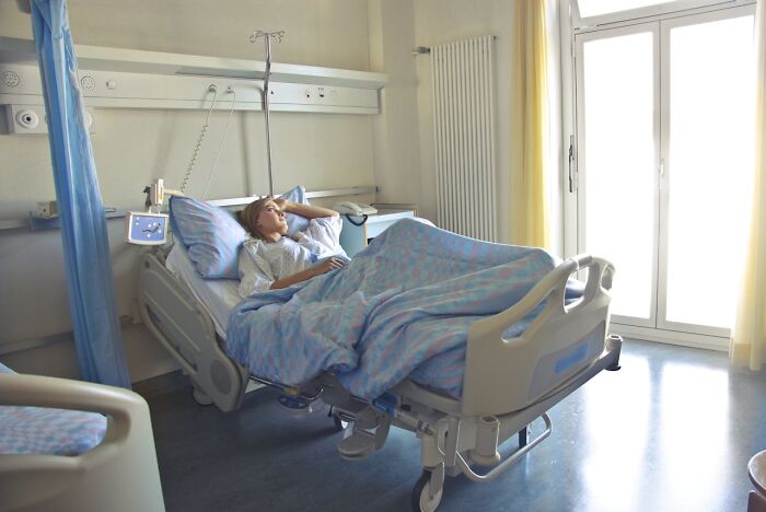 Patient lying in hospital bed looking thoughtful, illustrating emotions related to talking to a psychopath.