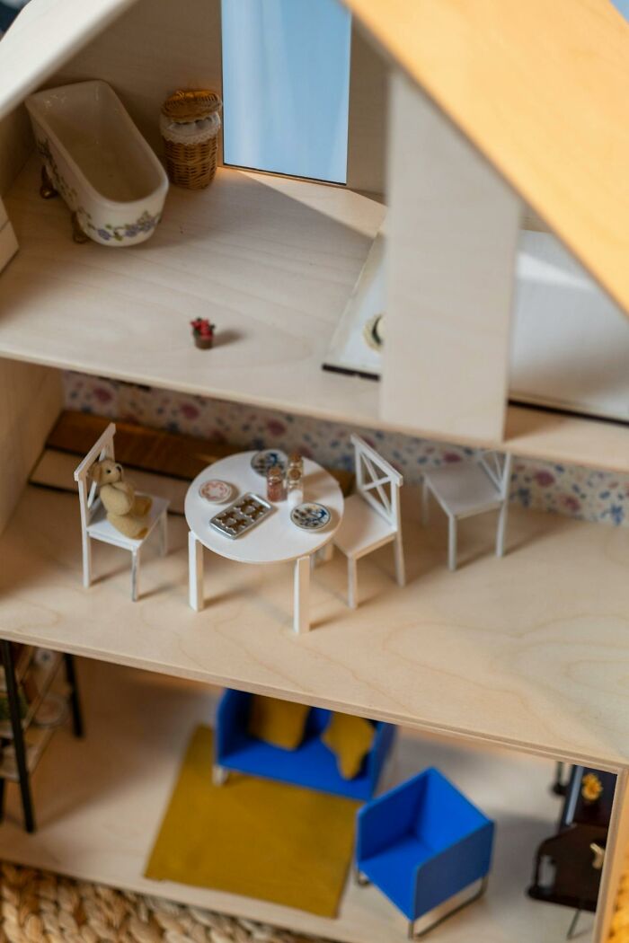 Miniature dollhouse interior with tiny furniture and a teddy bear, evoking night shift workers paranormal encounters theme.