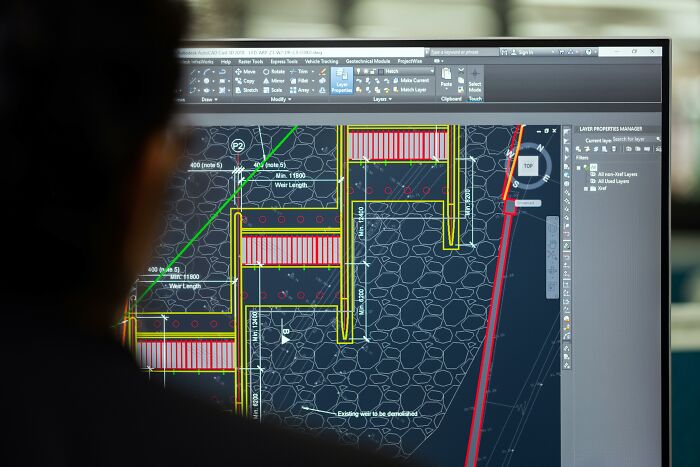 Person analyzing detailed technical drawings on a computer screen illustrating tiny human mistakes that impacted history.