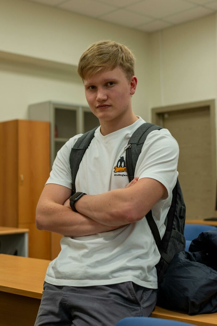 Young man with a serious expression and backpack, symbolizing moments of realizing talking to a psychopath.