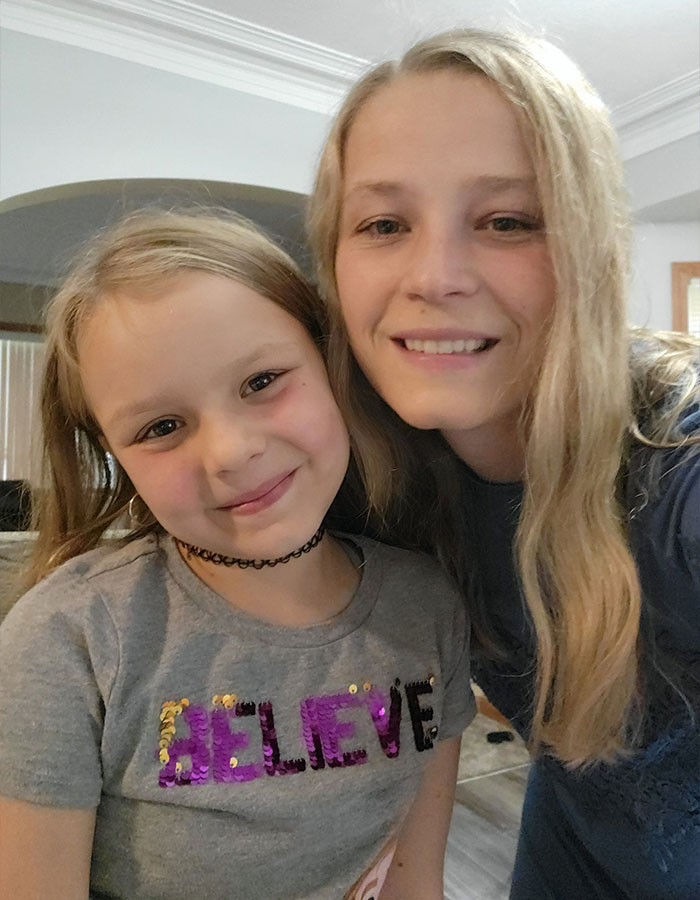 Young mother and daughter smiling together indoors before heartbreaking final phone call and explosion tragedy.