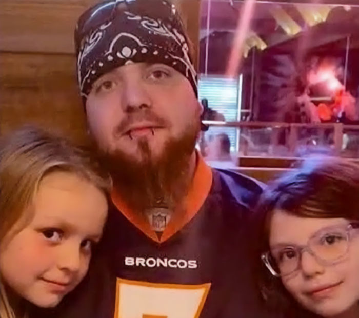 Man posing with his two daughters, captured in a heartfelt moment before the tragic explosion incident.