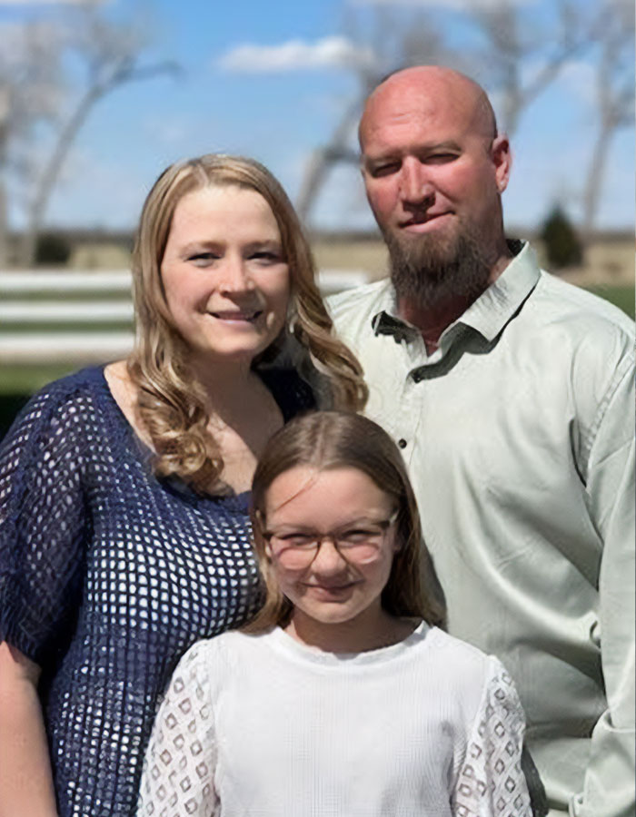 Family portrait of a man, his wife, and daughter before heartbreaking final phone call and tragic explosion incident.