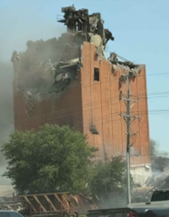 Partially collapsed building with smoke rising after horrific explosion linked to heartbreaking final phone call man made to wife and daughters