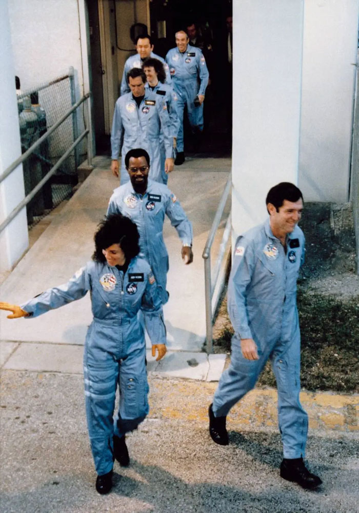 Astronauts walking in blue flight suits, a photo taken before disaster illustrating foreshadowing unfortunate events.