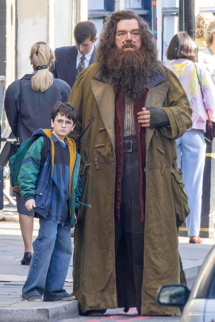 Actors in Harry Potter costumes on set, capturing a behind-the-scenes moment from the popular movie series. Actors in Harry Potter costumes on set, capturing a behind-the-scenes moment from the popular movie series.