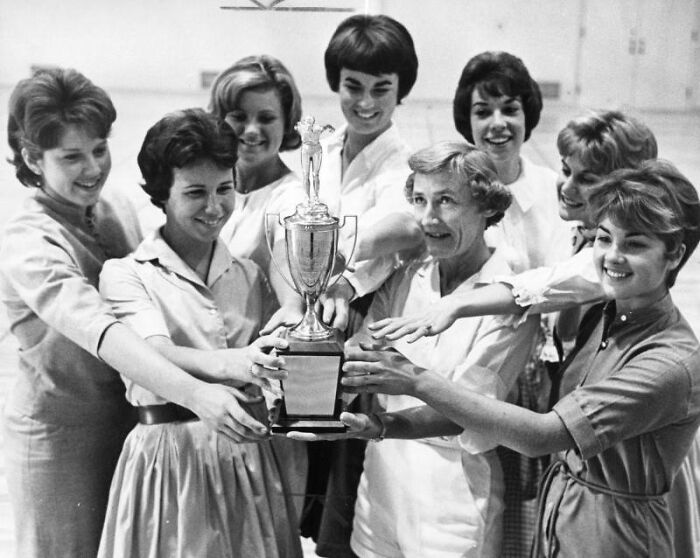 Group of LA women from 1962 joyfully holding a trophy together, celebrating achievement and living their best lives.