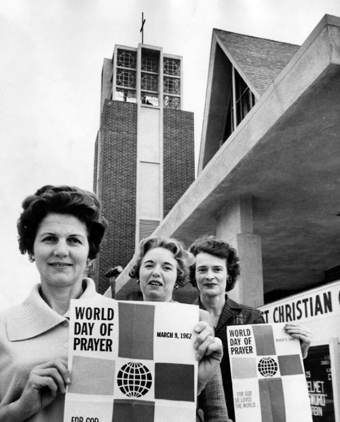 Three LA women in 1962 holding World Day of Prayer flyers outside a church, living their best lives in historic Los Angeles.