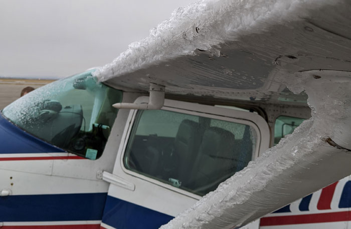 Small airplane wing and cockpit covered in ice, illustrating pilots facing the most terrifying situation in flight.