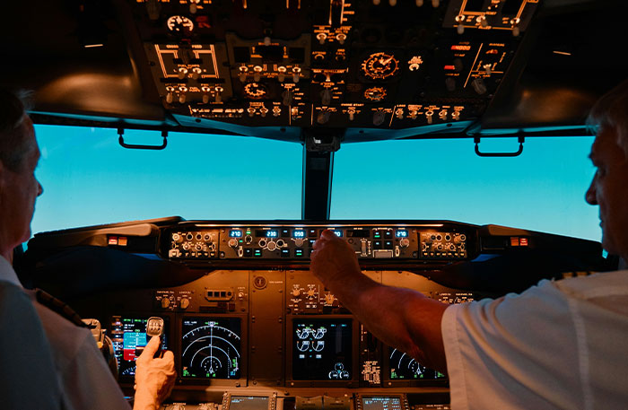 Two pilots in a cockpit operating controls during a flight, illustrating terrifying situations experienced by pilots.