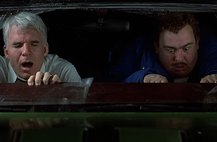 Two men in a car experiencing a terrifying situation, depicting fear and tension from pilots' most frightening moments.