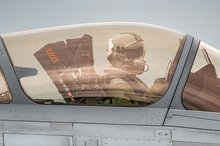 Pilot wearing helmet and oxygen mask inside cockpit, illustrating terrifying situations experienced by pilots in flight.