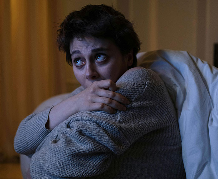 Person looking anxious and tense indoors, illustrating memorable wild situations cops had to deal with.