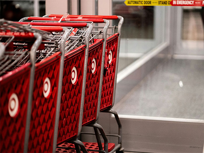 Red shopping carts lined up near an automatic door, illustrating memorable wild situations cops had to deal with.