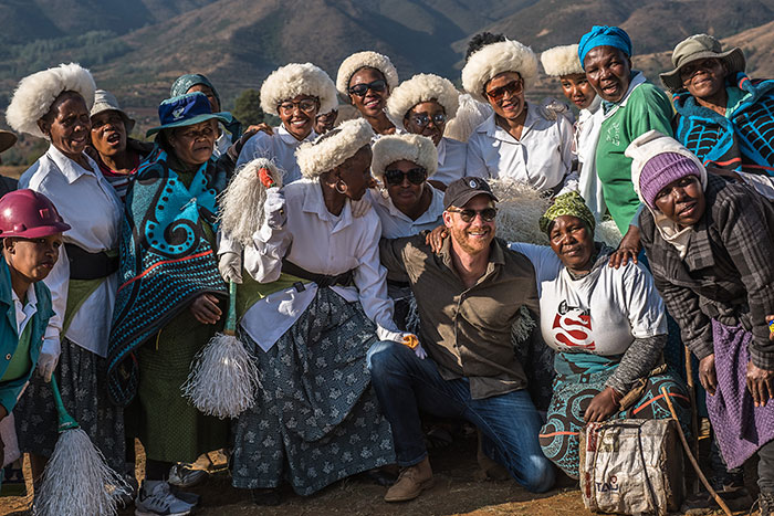 Prince Harry breaks silence after Sentebale scandal investigation ends, surrounded by women in traditional attire outdoors. - 4