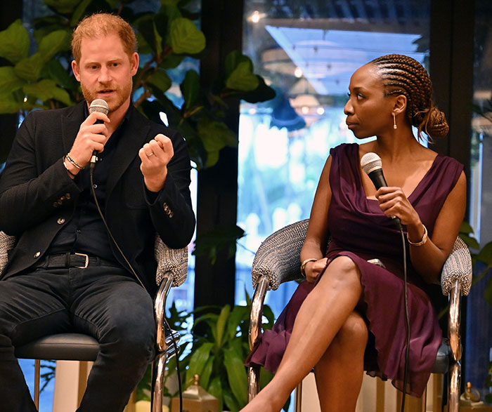Prince Harry speaking into a microphone during a discussion after Sentebale scandal investigation findings go public. - 9