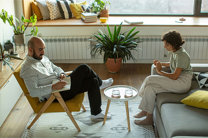 Woman and psychiatrist in a session, woman appearing confused by psychiatrist’s unhinged request in a cozy room setting. Woman and psychiatrist in a session, woman appearing confused by psychiatrist’s unhinged request in a cozy room setting.