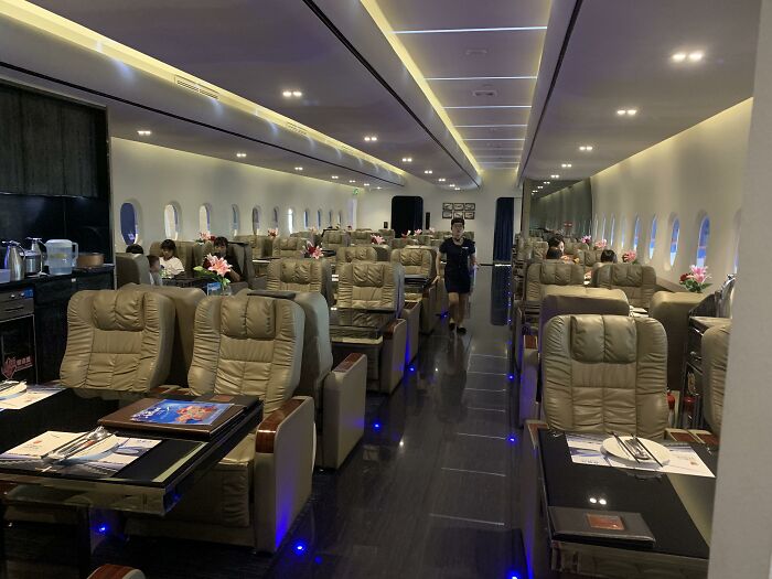 Luxury airplane restaurant interior with plush seating and elegant table settings in a creative bars and restaurants design.