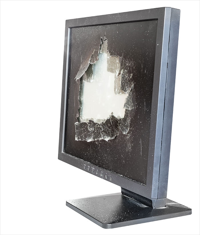 Broken computer monitor with shattered screen, representing rage room customers needing therapy and stress relief activities.