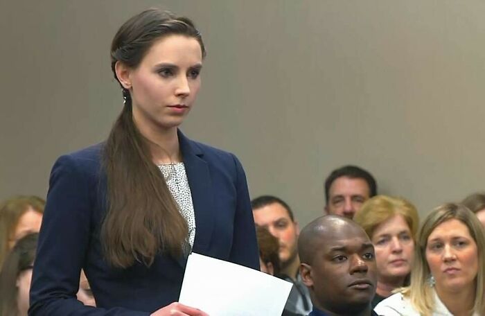 Young woman in a courtroom setting holding papers, one of 42 videos that don’t seem special until you know more context. - 26