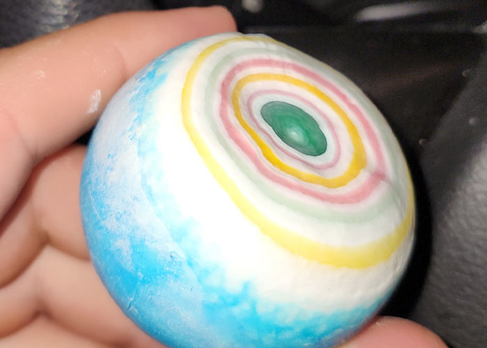 Hand holding a colorful layered ball, illustrating times people thought they were paranoid but faced real-life terror.