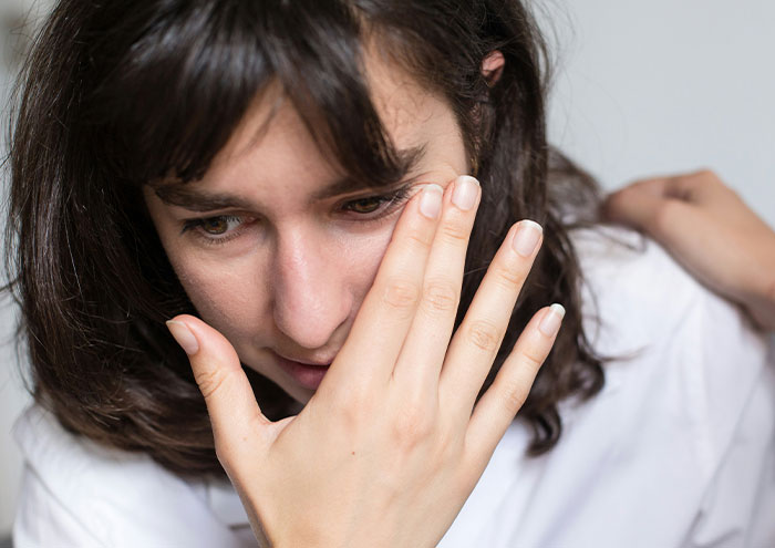 Woman feeling unsafe and anxious, trusting that gut feeling about concerning behaviors from men.
