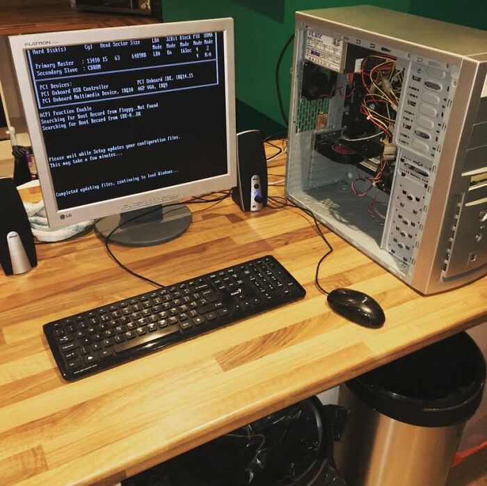 Vintage desktop computer setup with open tower case and CRT monitor displaying retro gaming and nostalgia boot screen.