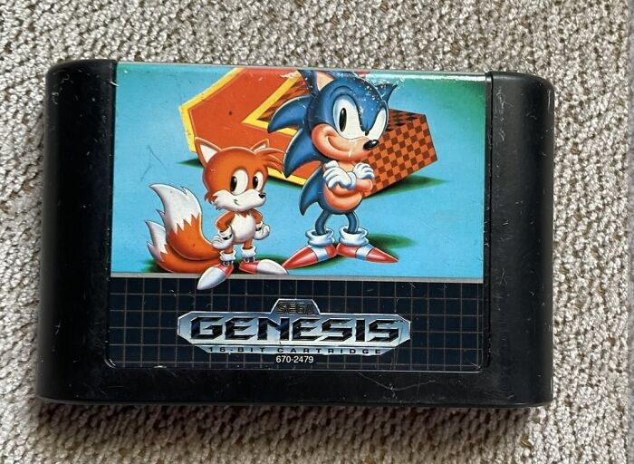 Sega Genesis retro gaming cartridge featuring Sonic the Hedgehog and Tails, evoking nostalgia from the ’80s to ’00s.