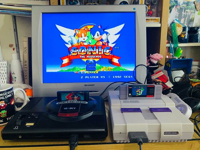 Retro gaming setup with classic Sonic the Hedgehog 2 on CRT TV, featuring Sega Genesis and Super Nintendo consoles.