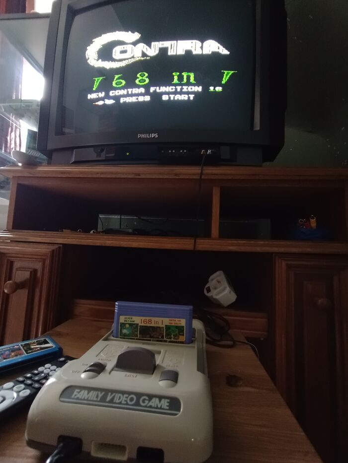 Retro gaming console setup with classic game cartridge running on a CRT TV, capturing nostalgia from the ’80s and ’90s.