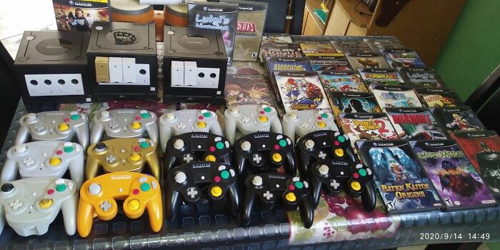 Collection of retro gaming consoles, controllers, and classic game cases from the ’80s, ’90s, and ’00s nostalgia era.