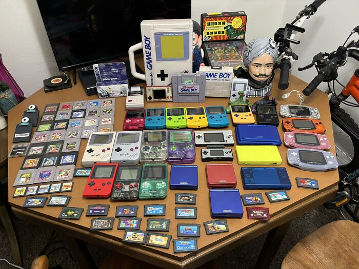 Collection of retro gaming consoles, handheld devices, and game cartridges showcasing nostalgia from the 80s, 90s, and 00s.