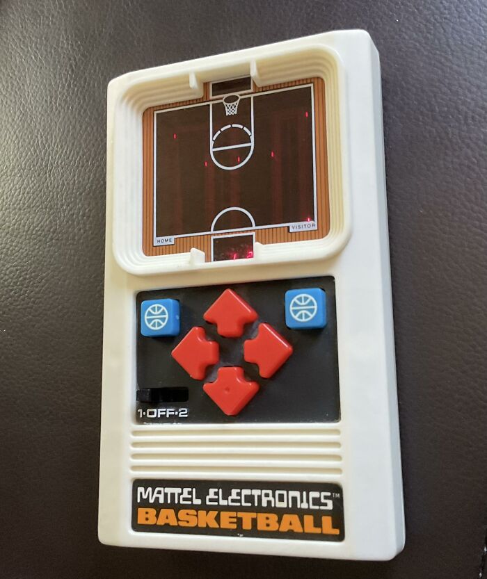 Retro gaming handheld basketball game by Mattel Electronics with red and blue buttons, evoking 80s and 90s nostalgia.