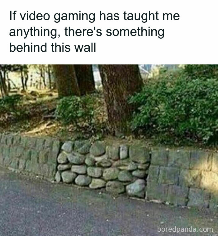 Stone wall with an unusual section of round rocks and text referencing retro gaming and hidden secrets behind walls.