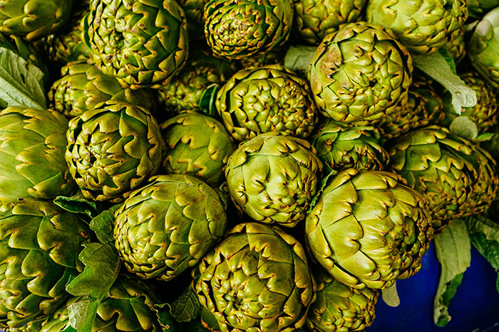 Close-up of fresh green artichokes, illustrating one of the absurd things rich people spend money on, seen firsthand.