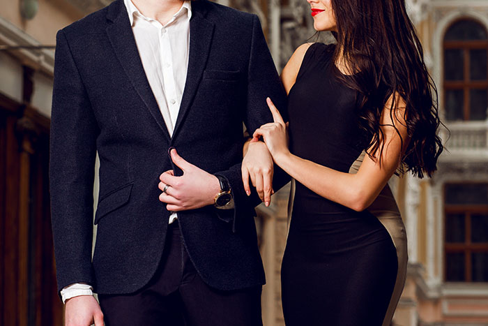 Couple dressed in elegant attire showcasing luxury fashion, illustrating absurd things rich people spend money on firsthand.