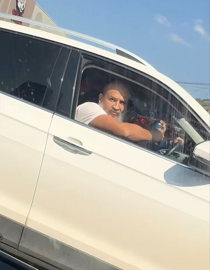 Man in white car showing road rage during coffee toss incident captured in viral instant karma video.