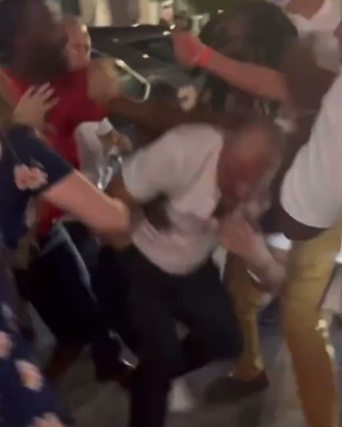 Crowded Cincinnati brawl scene showing a man being attacked with a swollen face sparking racial tensions.