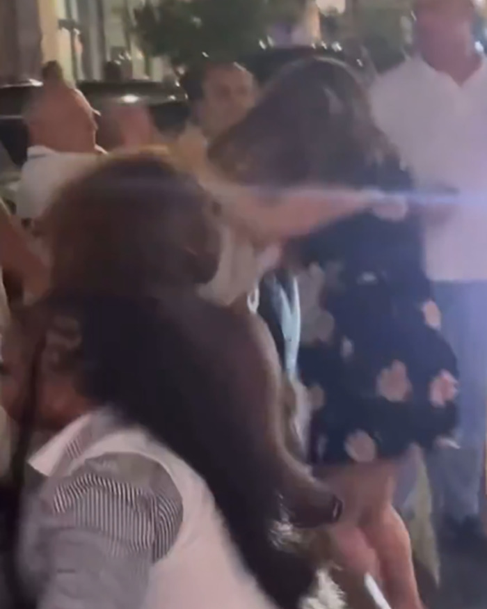 Crowd gathered at night during a Cincinnati brawl with tension visible among people in the scene.